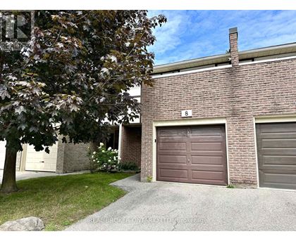 A house with a brown garage door is for sale.
