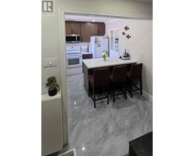 A kitchen with a table and chairs in the middle of the room.