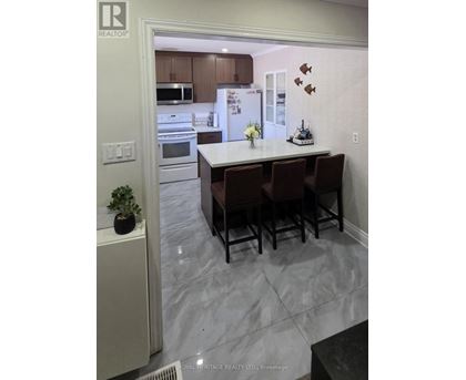 A kitchen with a table and chairs in the middle of the room.