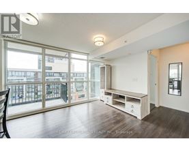 A spacious room with a balcony and sliding glass doors.
