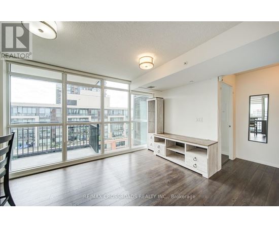 A spacious room with a balcony and sliding glass doors.