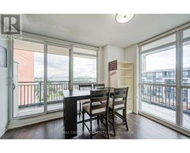 A dining room with a table and chairs and a view of the city.