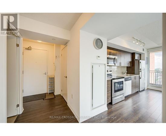A modern kitchen with white cabinets and stainless steel appliances.