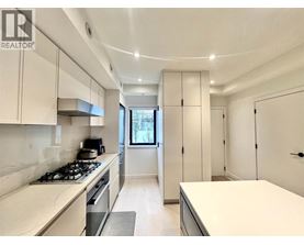 A modern kitchen with white cabinets and a stove top oven.