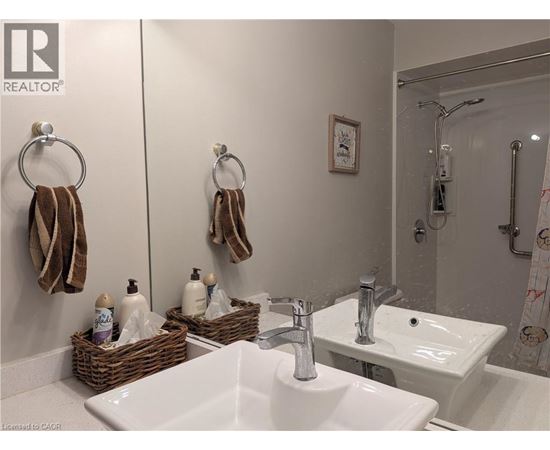 A bathroom with two sinks and a mirror.