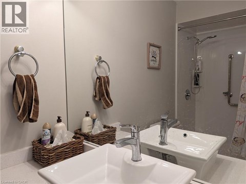 A bathroom with two sinks and a mirror.