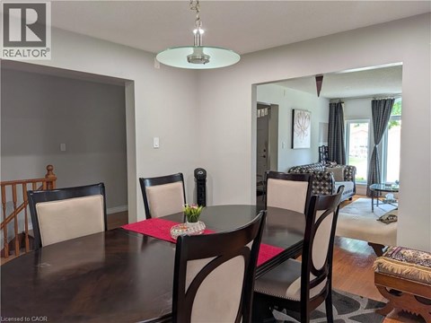 A dining room with a wooden table and chairs.