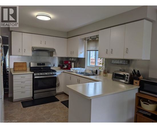 A kitchen with white cabinets and a large island.
