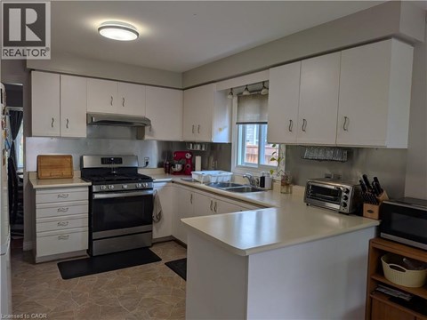 A kitchen with white cabinets and a large island.