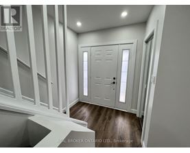 A white door with a black handle is in a room with white walls.