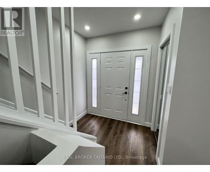 A white door with a black handle is in a room with white walls.
