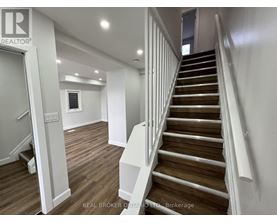 A staircase with wooden steps and white railings.