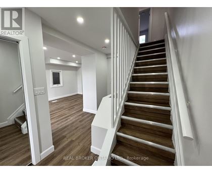 A staircase with wooden steps and white railings.