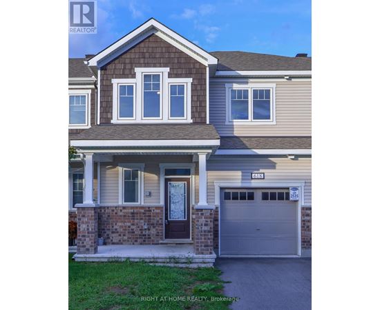 A house with a brown door and a garage door numbered 2535.