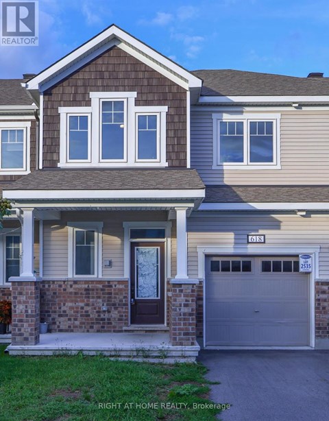 A house with a brown door and a garage door numbered 2535.
