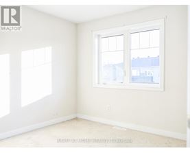 A room with a window and a wall with a logo that says REALTOR.