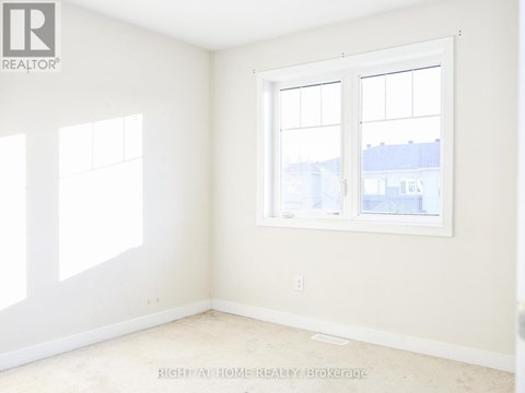A room with a window and a wall with a logo that says REALTOR.