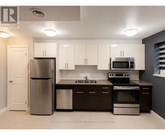A kitchen with white cabinets and stainless steel appliances.