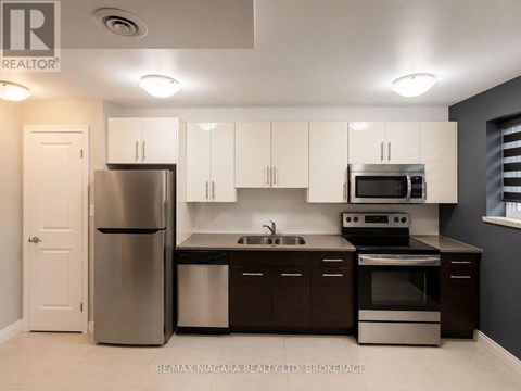 A kitchen with white cabinets and stainless steel appliances.