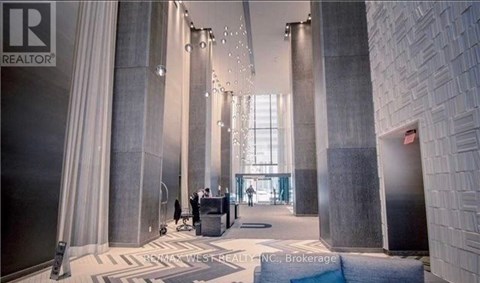A lobby with a lot of columns and people walking around.