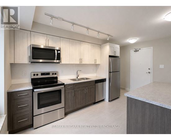 A kitchen with a stove, oven, microwave, and refrigerator.