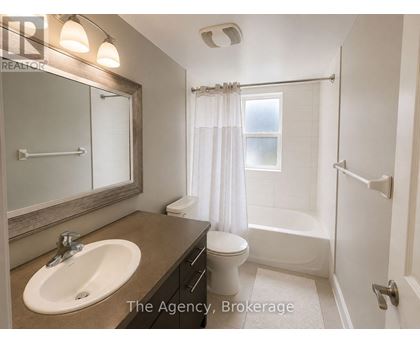 A bathroom with a sink, toilet, and bathtub.