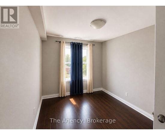 A room with a sliding glass door and a window with curtains.