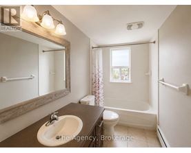 A bathroom with a sink, toilet, and bathtub.