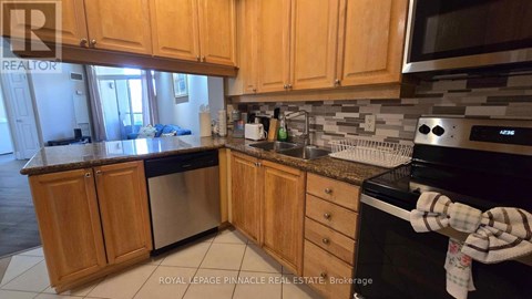 A kitchen with wooden cabinets and a black stove top oven.