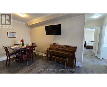 A dining room with a wooden table and chairs.