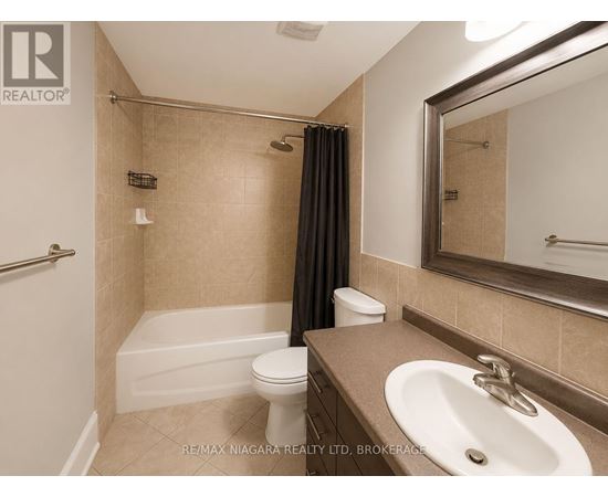A bathroom with a toilet, sink, and bathtub.