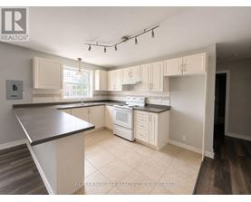 A kitchen with white appliances and cabinets.