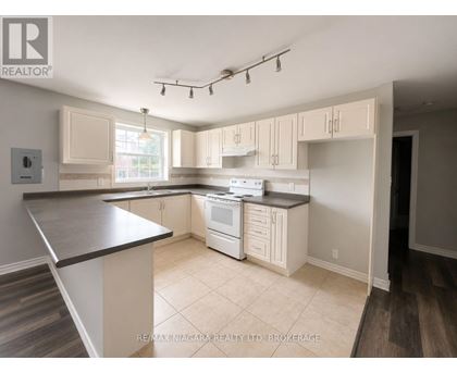 A kitchen with white appliances and cabinets.