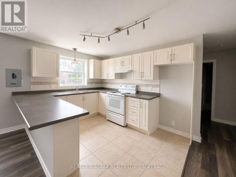 A kitchen with white appliances and cabinets.