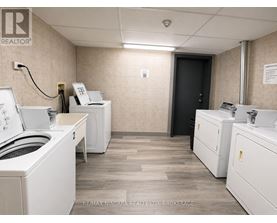 A brokerage office with two desks and a printer.