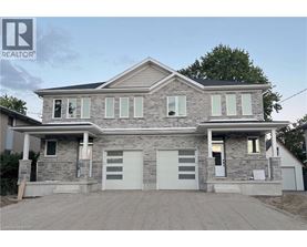A two-story house with a garage is for sale.