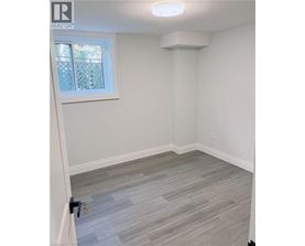 A room with a window and a grey floor.