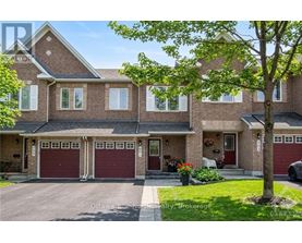 A large brick house with a tree in front.