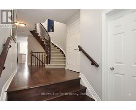 A staircase with a wooden floor and white walls.