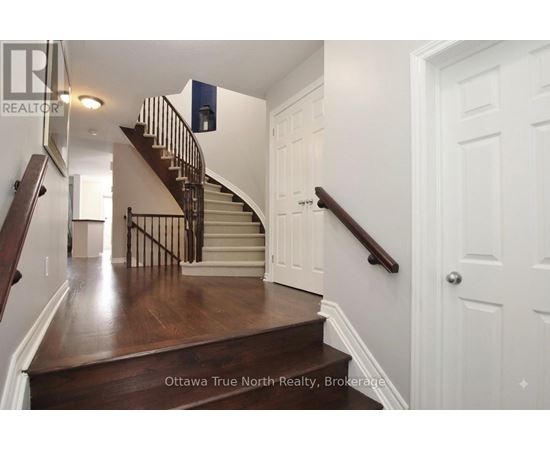 A staircase with a wooden floor and white walls.