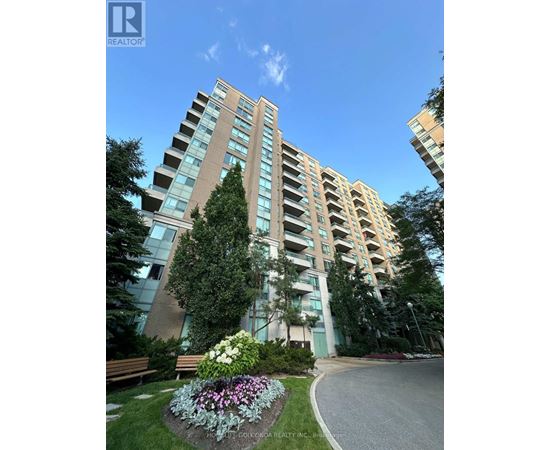 A tall residential building with a well-maintained garden in front.