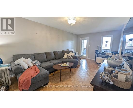 A living room with a grey sofa and a coffee table.