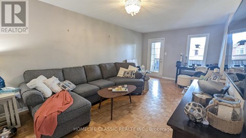 A living room with a grey sofa and a coffee table.