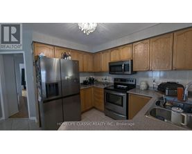 A kitchen with wooden cabinets and stainless steel appliances.