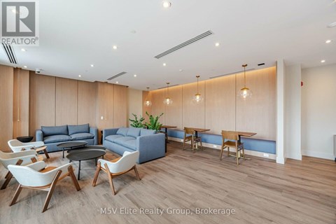 A modern living room with a dining table and chairs.