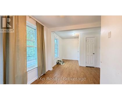 A room with a window and a door is shown in the image.