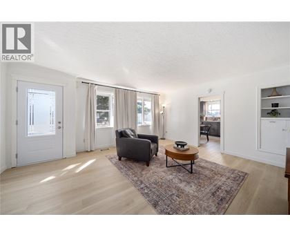 A living room with a grey couch and a coffee table.