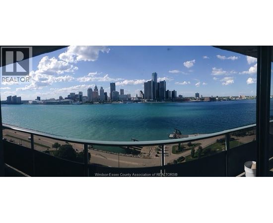 A city skyline is seen from a balcony.