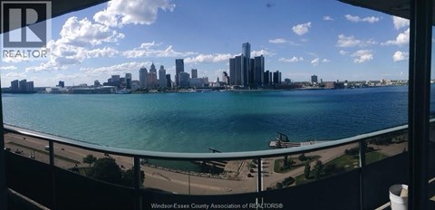 A city skyline is seen from a balcony.