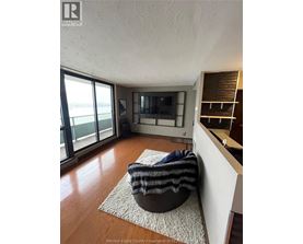 A living room with a chair and a television.